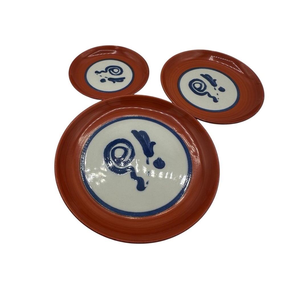This is a Japanese Arita ware plate with a persimmon red glaze.